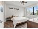 Bright bedroom featuring modern ceiling fan, hardwood floors, large windows, and minimalist decor at 907 Arlington N Ave, St Petersburg, FL 33705