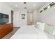 Bedroom with hardwood floors, natural light, modern ceiling fan, and tastefully appointed furniture at 907 Arlington N Ave, St Petersburg, FL 33705