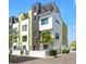 Striking modern townhomes feature a sleek design with black accents, white walls, and a private rooftop terrace at 907 Arlington N Ave, St Petersburg, FL 33705