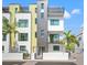 Modern townhome with a black brick accent, balconies, gated entry, and well maintained landscaping at 907 Arlington N Ave, St Petersburg, FL 33705