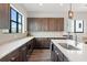 An open kitchen features white countertops, modern cabinetry, stainless appliances and sleek pendant lighting at 907 Arlington N Ave, St Petersburg, FL 33705