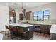 Bright kitchen with stainless appliances, center island and barstool seating, stylish pendants, and large window at 907 Arlington N Ave, St Petersburg, FL 33705