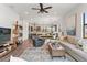 Open-concept living room featuring hardwood floors, stylish decor, and ample natural light at 907 Arlington N Ave, St Petersburg, FL 33705