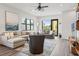 Bright, open living room featuring hardwood floors, plush seating, and a ceiling fan at 907 Arlington N Ave, St Petersburg, FL 33705