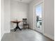 Minimalist living space with a round table and chair near a glass door to a balcony with city views at 907 Arlington N Ave, St Petersburg, FL 33705