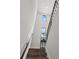 Bright stairway with natural light, wood stairs, black handrail, and stylish decor at 907 Arlington N Ave, St Petersburg, FL 33705
