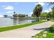 Scenic waterfront view with palm trees and walking path on a sunny day at 907 Arlington N Ave, St Petersburg, FL 33705