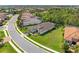 Aerial view of a well-maintained home with a screened-in patio and lush green lawn in a lovely community at 10505 Inglenook Ter, Palmetto, FL 34221
