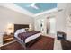 Spacious bedroom featuring tray ceilings, modern lighting, and a cozy brown rug at 10505 Inglenook Ter, Palmetto, FL 34221
