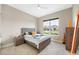 Cozy bedroom with natural light, ceiling fan, neutral walls and tile floors at 10505 Inglenook Ter, Palmetto, FL 34221