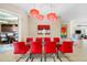 Open dining area featuring a glass table, red chairs, and stylish lighting at 10505 Inglenook Ter, Palmetto, FL 34221