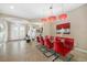 Dining room features a glass table with red chairs and modern lighting at 10505 Inglenook Ter, Palmetto, FL 34221
