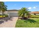 Inviting home with brick driveway, manicured lawn, and lush landscaping at 10505 Inglenook Ter, Palmetto, FL 34221