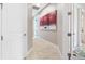 Bright hallway featuring neutral walls, tiled floors, and modern artwork at 10505 Inglenook Ter, Palmetto, FL 34221