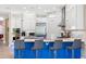 Bright kitchen featuring a blue island with seating, stainless steel appliances, and ample cabinet space at 10505 Inglenook Ter, Palmetto, FL 34221