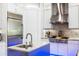 Updated kitchen with stainless steel appliances, custom range hood, and an island with a sink at 10505 Inglenook Ter, Palmetto, FL 34221
