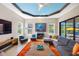 Comfortable living room with tray ceiling and direct view and access to outdoor pool area at 10505 Inglenook Ter, Palmetto, FL 34221