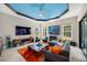 Stylish living room with vibrant blue ceiling and cozy seating arrangement at 10505 Inglenook Ter, Palmetto, FL 34221
