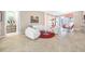 Open concept living room features tile floors, white furniture, and access to dining area at 10505 Inglenook Ter, Palmetto, FL 34221