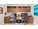 Office space with dual workstations, built-in shelving, and ample storage at 10505 Inglenook Ter, Palmetto, FL 34221