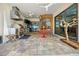 Spacious covered outdoor kitchen with ceiling fans, bar seating, stainless appliances, and access to the pool at 10505 Inglenook Ter, Palmetto, FL 34221
