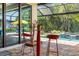 Outdoor seating at a bar table on the patio overlooking the swimming pool and spa at 10505 Inglenook Ter, Palmetto, FL 34221