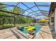 Inviting screened-in pool area with a yellow raft, spa, and lush green surroundings at 10505 Inglenook Ter, Palmetto, FL 34221