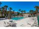 The community pool has plenty of seating, palm trees, and a pool house at 106 Windward Pl, Oldsmar, FL 34677