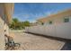 Paver backyard with white fence offers privacy and space for recreation and gardening at 1129 Haley Ln, Dunedin, FL 34698