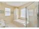 Well-lit bathroom showcasing a garden tub and a glass-enclosed shower at 1129 Haley Ln, Dunedin, FL 34698