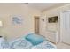 Bedroom featuring a queen-sized bed, white dresser, and soft lighting, perfect for a restful night's sleep at 1129 Haley Ln, Dunedin, FL 34698