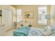 Well-lit bedroom featuring a white desk, plantation shutters, and a closet, perfect for a restful night's sleep at 1129 Haley Ln, Dunedin, FL 34698
