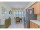 Dining room with stainless steel refrigerator, neutral walls, and bay windows with shutter shades at 1129 Haley Ln, Dunedin, FL 34698