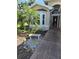 Inviting front entrance with decorative plants and a bench for curb appeal at 1129 Haley Ln, Dunedin, FL 34698