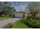 Charming home exterior with well-manicured landscaping, a two-car garage, and a welcoming driveway at 1129 Haley Ln, Dunedin, FL 34698