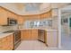 Bright kitchen with stainless steel appliances, light wood cabinets, and lots of natural light at 1129 Haley Ln, Dunedin, FL 34698