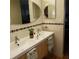 Bathroom featuring double sinks and an oval mirror above the vanity at 113 Nina Way # 113, Oldsmar, FL 34677
