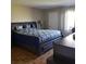 Comfortable bedroom features a large bed with stylish bedding, complemented by a window and closet at 113 Nina Way # 113, Oldsmar, FL 34677
