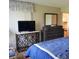 Bedroom with a TV on a marble top console and a dresser with a mirror at 113 Nina Way # 113, Oldsmar, FL 34677