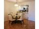 Cozy dining area next to a kitchen with a view of white cabinets and a breakfast bar at 113 Nina Way # 113, Oldsmar, FL 34677