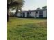 Well-maintained condo building surrounded by a lush green lawn showcasing the community's landscape at 113 Nina Way # 113, Oldsmar, FL 34677