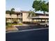 Condo building with car port, showcasing landscaping, and ample parking in a well-maintained community at 113 Nina Way # 113, Oldsmar, FL 34677