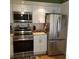 Kitchen featuring stainless steel appliances, white cabinets and granite counters at 113 Nina Way # 113, Oldsmar, FL 34677