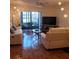Bright living room with modern decor, comfortable sofas, and a view of the screened-in lanai at 113 Nina Way # 113, Oldsmar, FL 34677