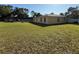 Extensive backyard featuring lush grass, a patio, and a home exterior at 11708 Nicklaus Cir, Tampa, FL 33624