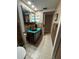 Rustic bathroom showcasing a vanity and beige tile flooring at 11708 Nicklaus Cir, Tampa, FL 33624