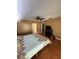 Comfortable bedroom with wood floors, ceiling fan, and a colorful quilt on the bed at 11708 Nicklaus Cir, Tampa, FL 33624