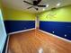 Bright bedroom featuring hardwood floors and ceiling fan at 11708 Nicklaus Cir, Tampa, FL 33624