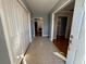 Entryway with tile floors, white closet doors, and open doorway into adjacent room at 11708 Nicklaus Cir, Tampa, FL 33624