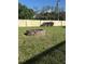Circular brick fire pit in a spacious backyard, ideal for outdoor gatherings at 11708 Nicklaus Cir, Tampa, FL 33624